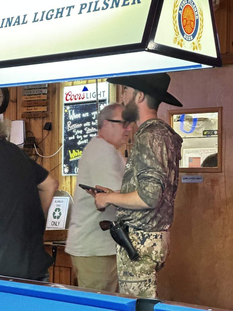 Crossing paths with someone carrying a gun on their belt, like many of their friends. A great shot by JP
